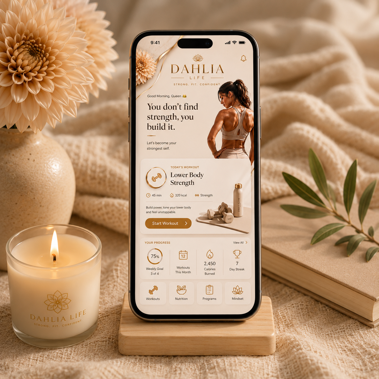 Dahlia Life App shown on a phone, styled with dumbbells and a candle